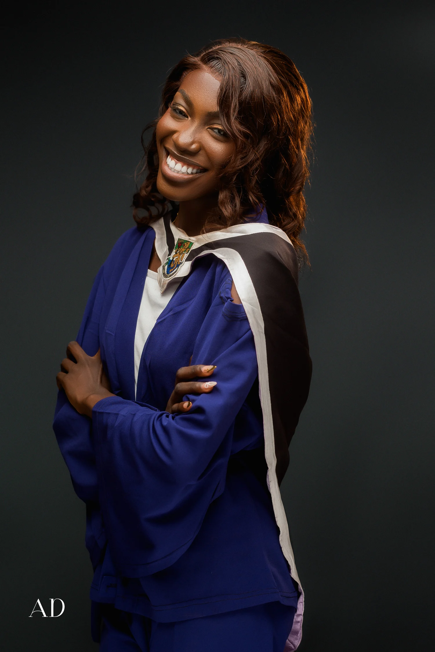Graduate in a blue gown, photographed by PhotosbyAD